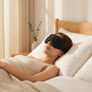 3D memory foam sleep mask resting on white linen pillow in a serene golden-hour bedroom