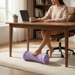Purple foot roller massager used under desk in calm modern home office